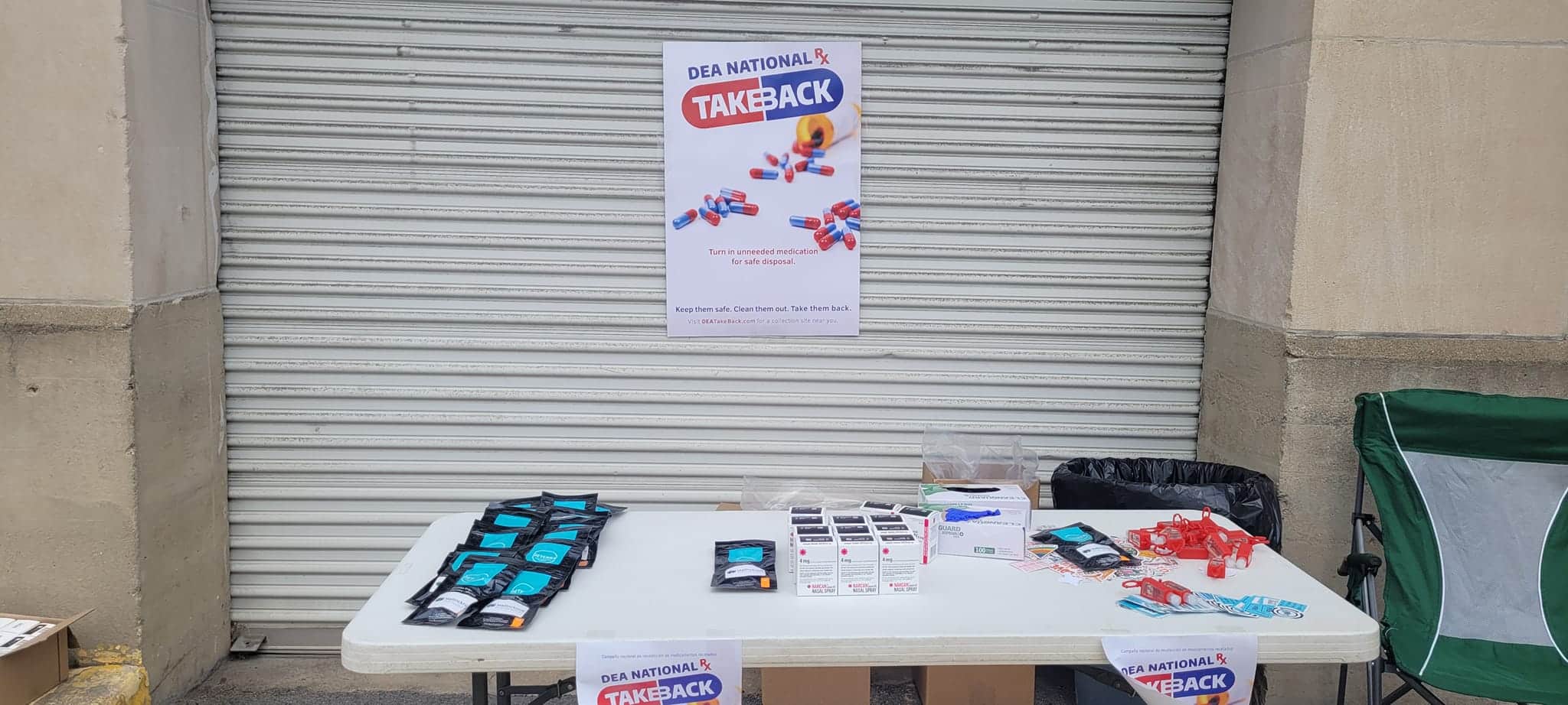 A table with supplies and handouts at a DEA National Take Back event.