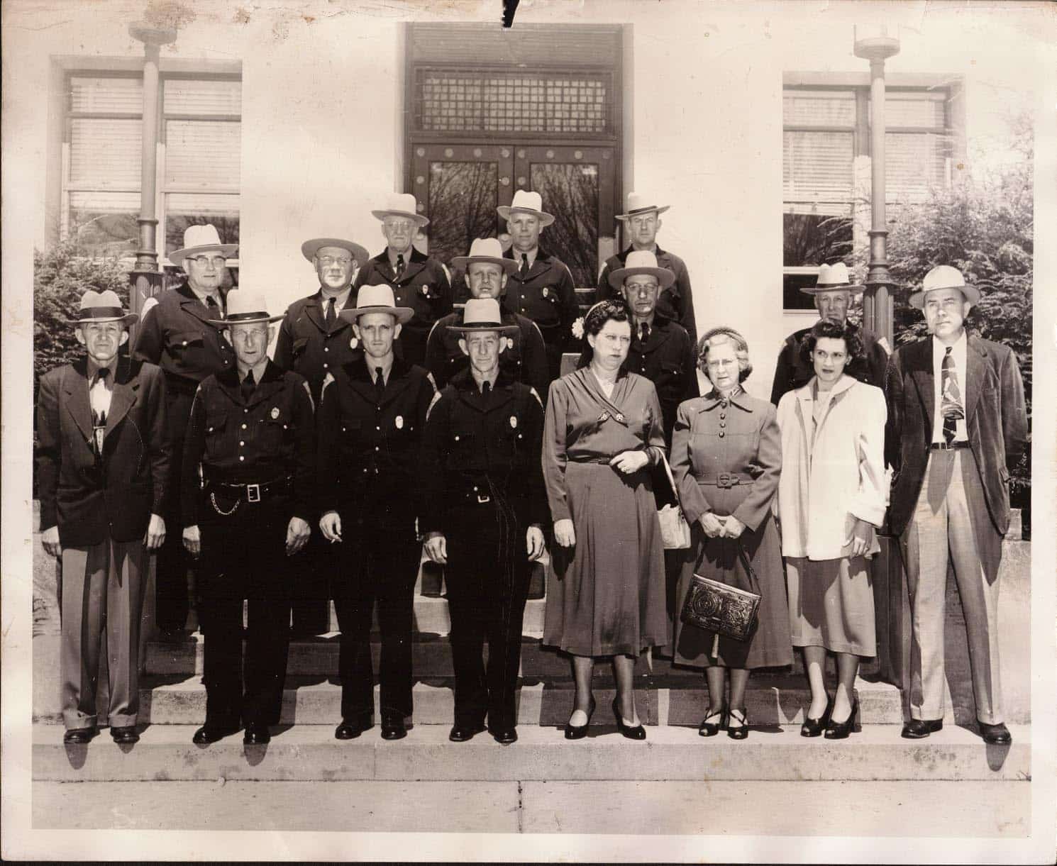 An old black and white photograph of the 1953 Mercer County Sheriff's Department deputies and staff posing in front of the County Courthouse.